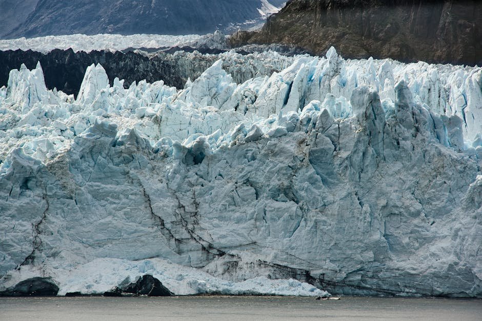 A breathtaking view of a massive glacier in Alaska, showcasing its icy formations and rugged beauty.