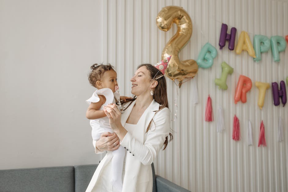 A mother and daughter enjoying a joyful birthday celebration indoors.