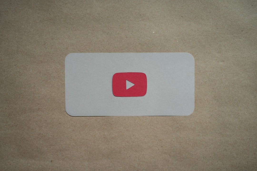 a red and white play button on a piece of paper