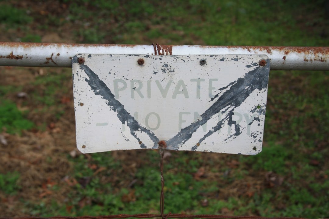 A sign that is attached to a fence
