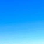 A serene view of a vibrant clear blue sky with a subtle gradient, perfect for backgrounds.