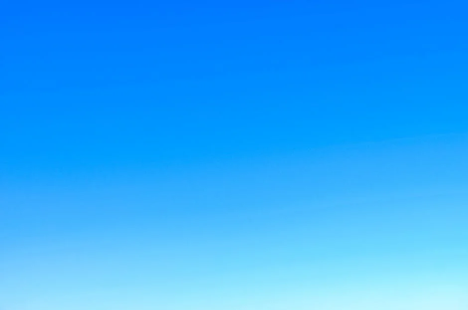 A serene view of a vibrant clear blue sky with a subtle gradient, perfect for backgrounds.