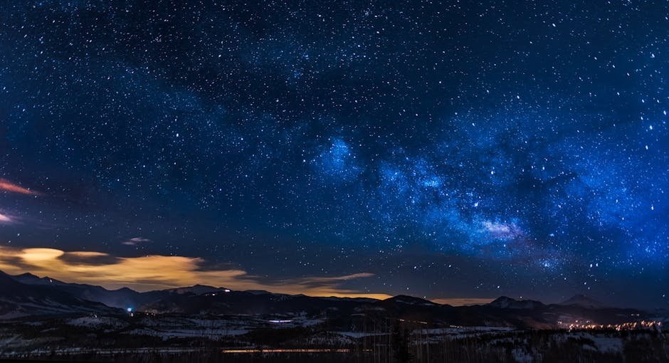 A breathtaking view of the Milky Way galaxy illuminating the night sky over mountains.