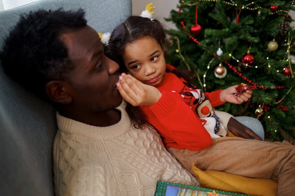 Father and daughter sharing a tender moment by the Christmas tree, enjoying the festive atmosphere.