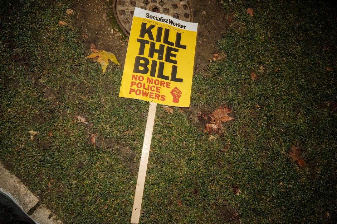 a yellow sign that says kill the bill on it
