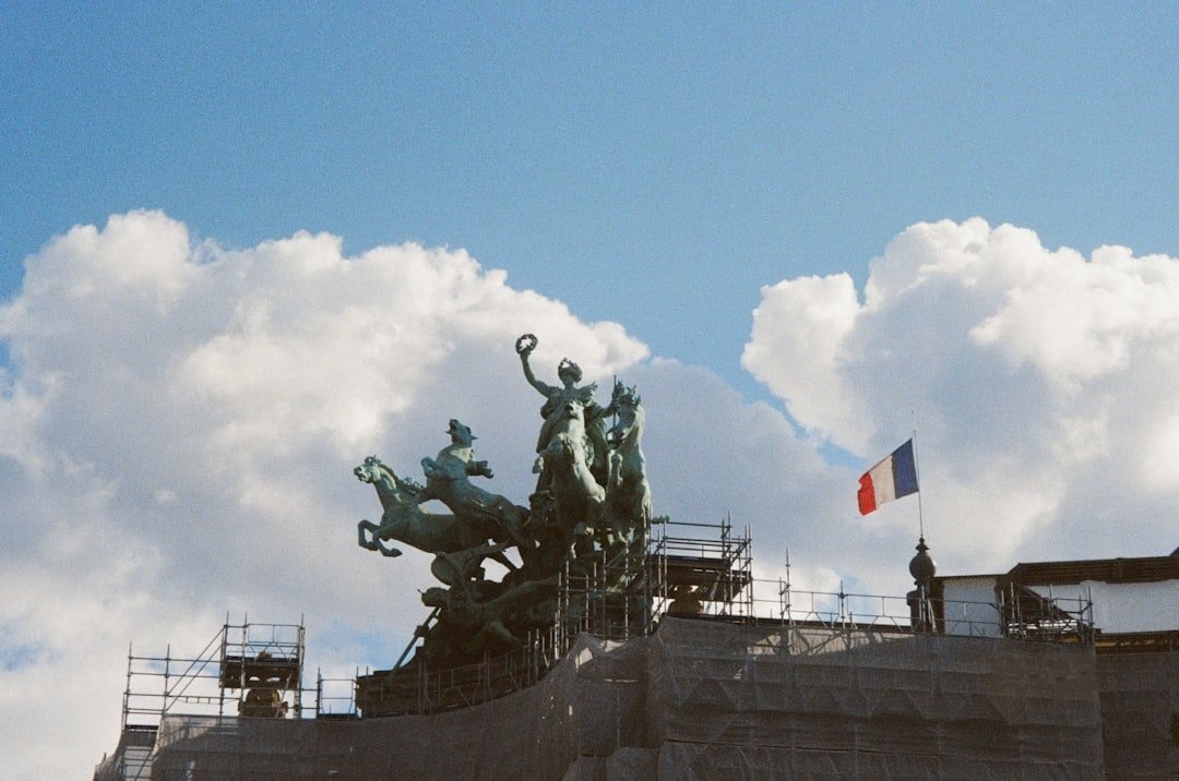 a statue on top of a building with scaffolding around it