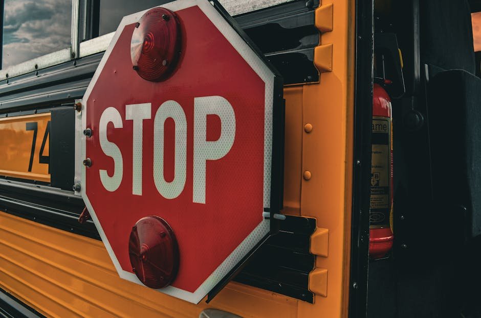 Detailed image of a 'STOP' sign on a school bus, emphasizing safety and transport.