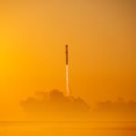 a rocket is flying through the air on a foggy day