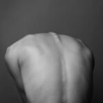 grayscale photo of persons back