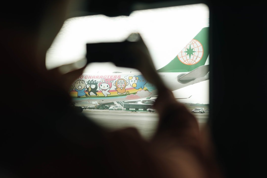 Someone is photographing a colorful airplane.