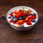 strawberry and blackberries on top of brown table